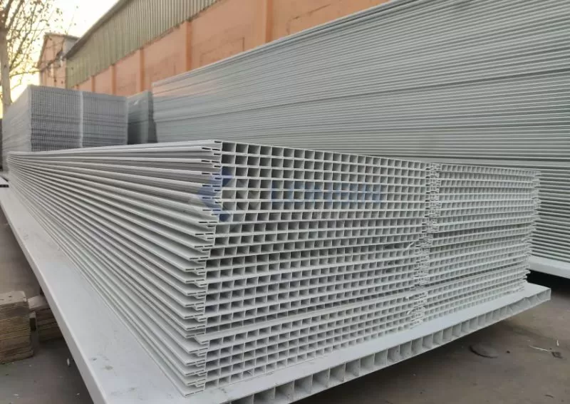 How do PVC partition panels improve pen hygiene and disease control